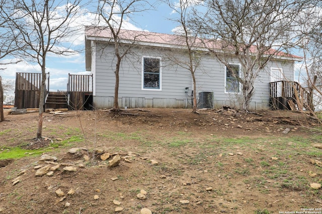 view of side of home featuring central AC unit