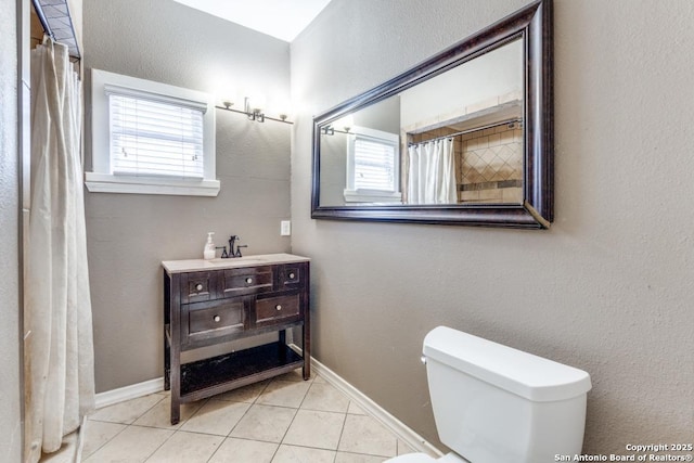 bathroom featuring tile patterned flooring, plenty of natural light, sink, and toilet