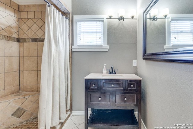 bathroom with sink, a shower with curtain, and a wealth of natural light