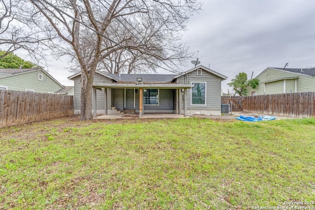 back of house with a yard, central AC, and a patio