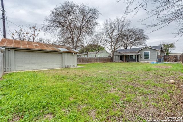 view of yard featuring a garage and an outdoor structure