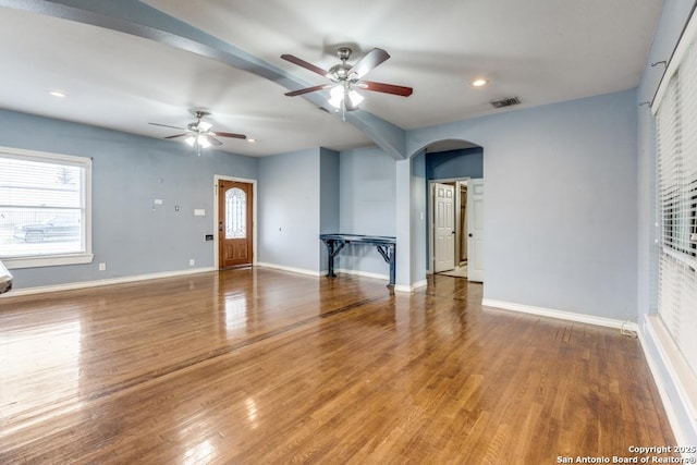 unfurnished living room with hardwood / wood-style flooring and ceiling fan