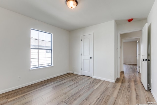 unfurnished bedroom with light wood-type flooring