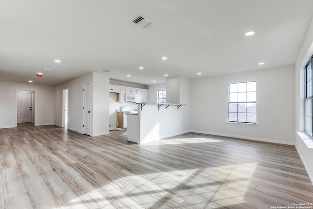 unfurnished living room featuring light wood-type flooring