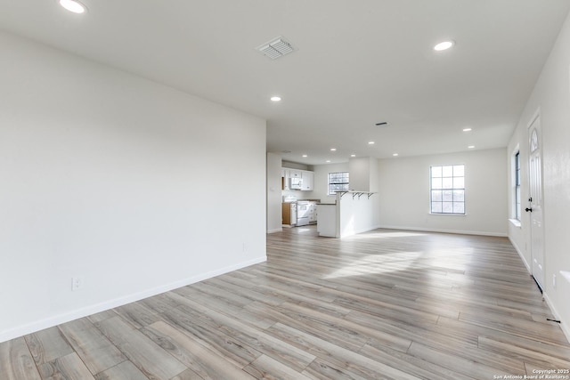 unfurnished living room with light hardwood / wood-style flooring