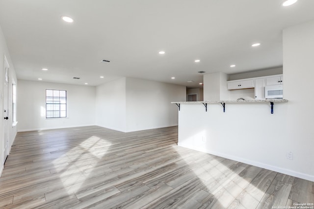 unfurnished living room featuring light wood-type flooring