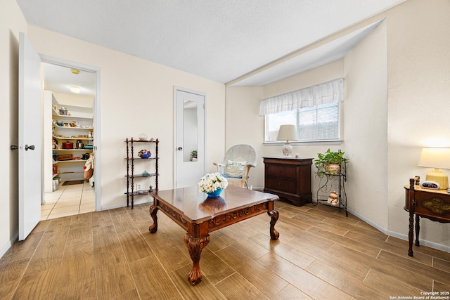 interior space with light hardwood / wood-style flooring and a textured ceiling