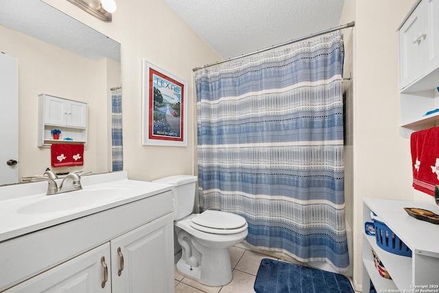 bathroom featuring tile patterned floors, toilet, a shower with curtain, a textured ceiling, and vanity