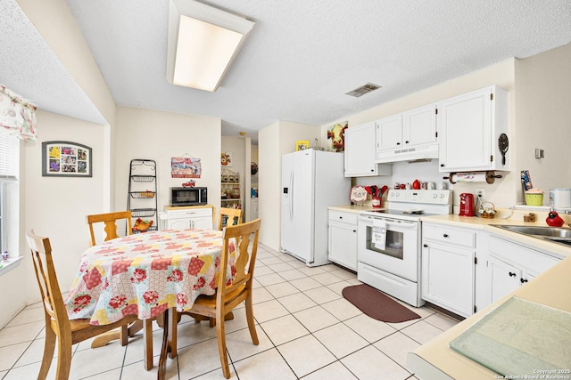 kitchen featuring white cabinetry, white appliances, sink, and light tile patterned floors