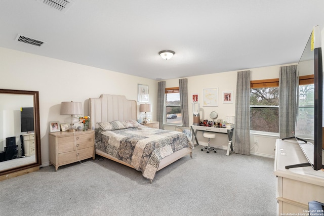 carpeted bedroom featuring multiple windows