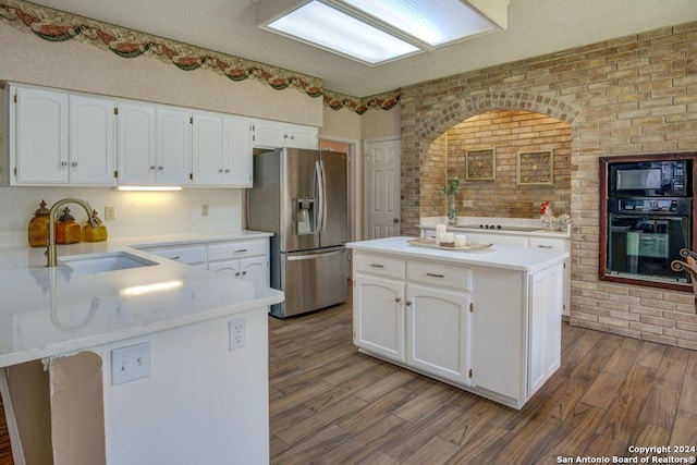 8907 Lost Bnd, San Antonio, TX 78240 - kitchen with white cabinets, sink, a kitchen island, and black appliances