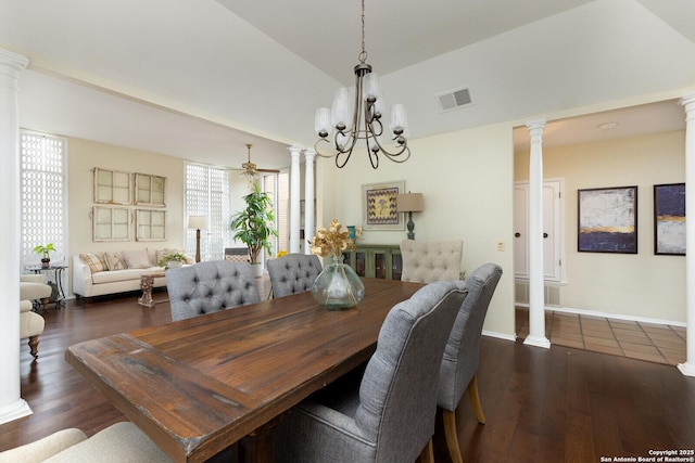 dining space featuring decorative columns, lofted ceiling, and dark wood-type flooring