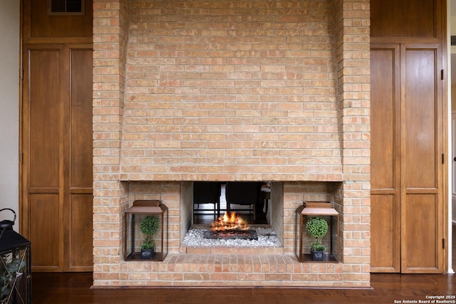 interior details with wood-type flooring and a fireplace