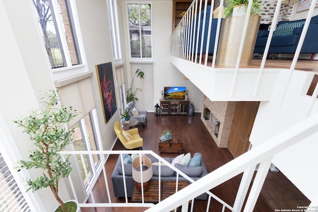 dining space featuring dark hardwood / wood-style floors and a high ceiling