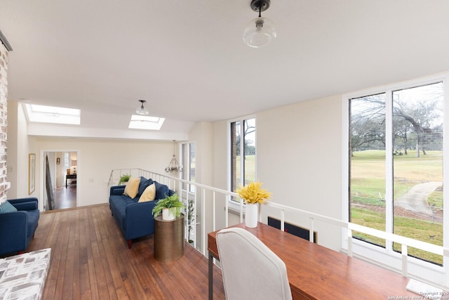 dining space featuring dark hardwood / wood-style flooring and a skylight