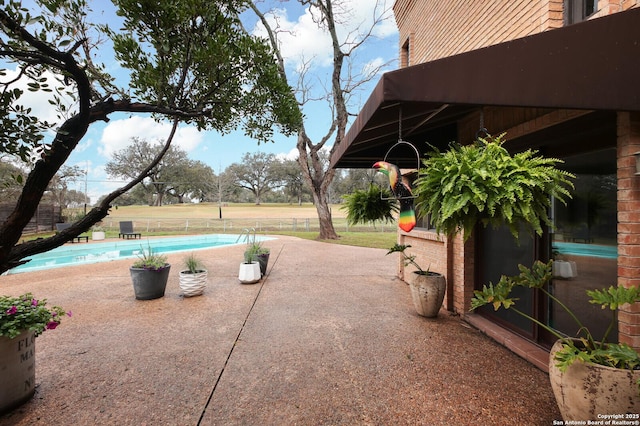 view of patio with a fenced in pool