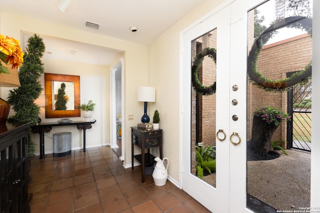 interior space featuring french doors and dark tile patterned floors