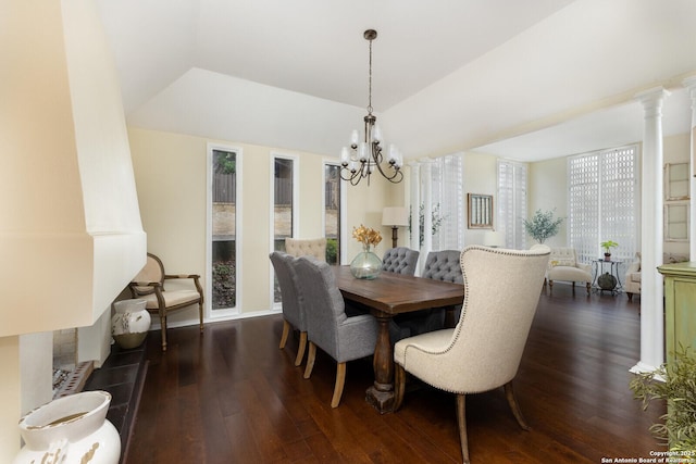 dining area with dark hardwood / wood-style flooring, decorative columns, and an inviting chandelier