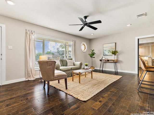 living area with baseboards, a ceiling fan, hardwood / wood-style flooring, a textured ceiling, and recessed lighting