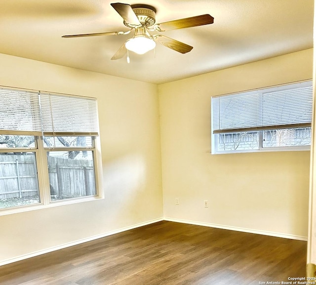 unfurnished room featuring dark hardwood / wood-style floors and ceiling fan