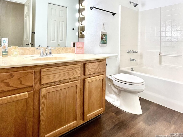 full bathroom with hardwood / wood-style flooring, vanity, toilet, and shower / bath combination