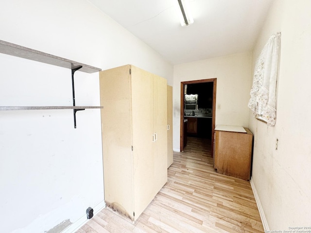 corridor with light hardwood / wood-style floors