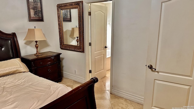 bedroom with light tile patterned floors