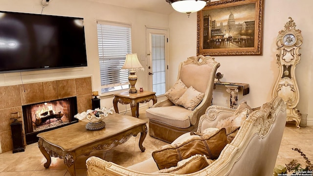 sitting room featuring a premium fireplace and light tile patterned floors