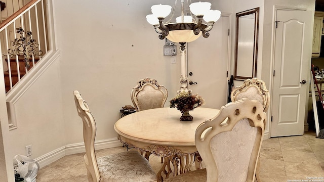 tiled dining space featuring a chandelier