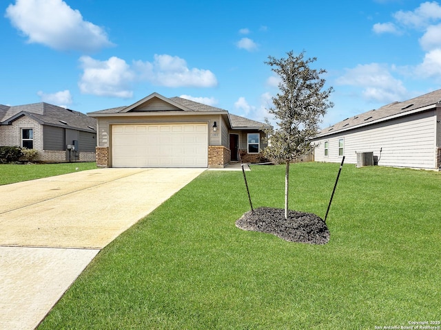 ranch-style house featuring a garage, central AC, and a front lawn