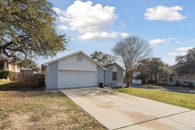 ranch-style home featuring a garage and a front yard