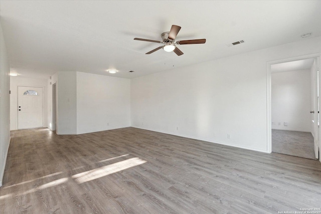 unfurnished room with ceiling fan and light wood-type flooring