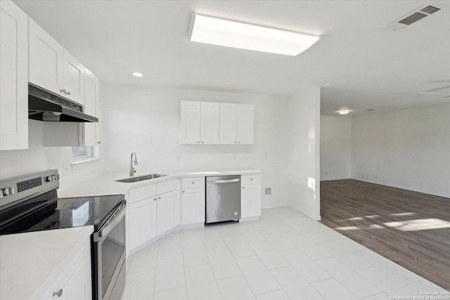 kitchen featuring sink, light hardwood / wood-style flooring, white cabinets, and appliances with stainless steel finishes