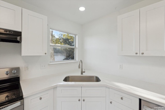 kitchen featuring electric stove, white cabinetry, range hood, and sink