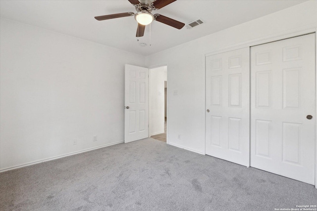 unfurnished bedroom with ceiling fan, light colored carpet, and a closet