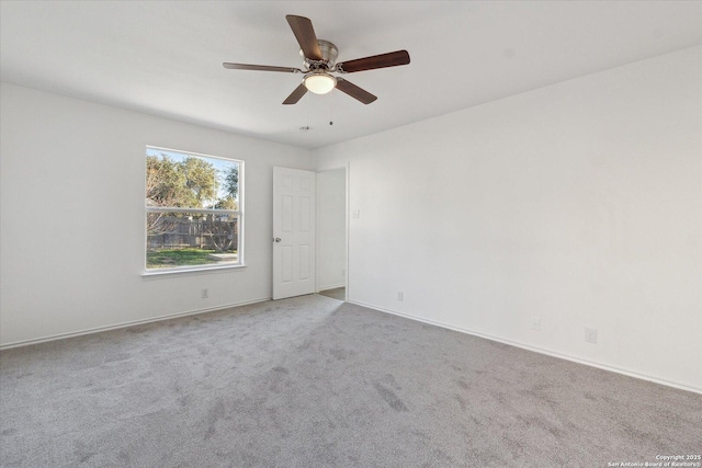 spare room with carpet floors and ceiling fan