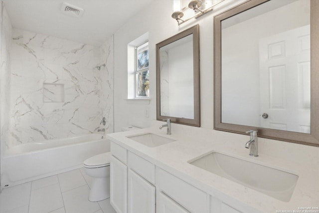 full bathroom featuring tiled shower / bath combo, vanity, tile patterned flooring, and toilet