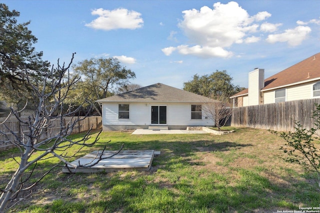 back of property with a patio and a lawn