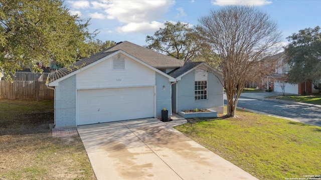 ranch-style house with a garage and a front lawn