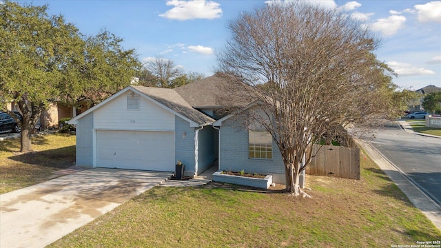 single story home with a garage and a front lawn