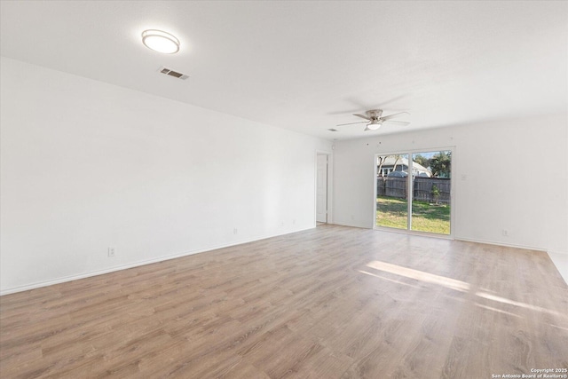 unfurnished room featuring ceiling fan and light wood-type flooring