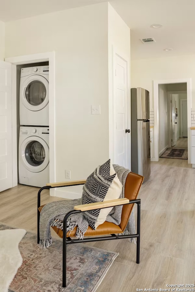 interior space featuring stacked washer and dryer and light wood-type flooring