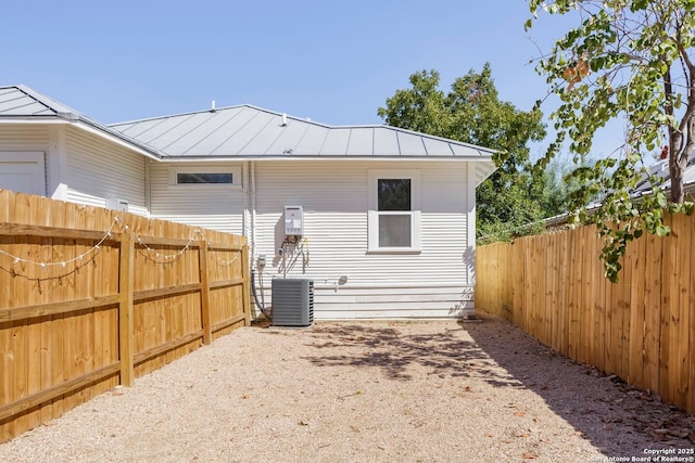 back of property featuring central AC