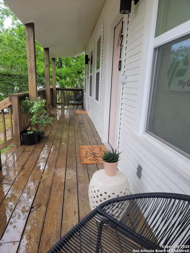 wooden terrace with a porch