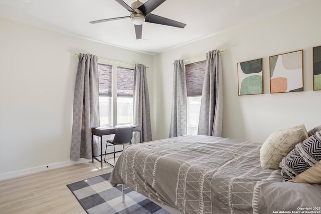 bedroom with light hardwood / wood-style flooring and ceiling fan