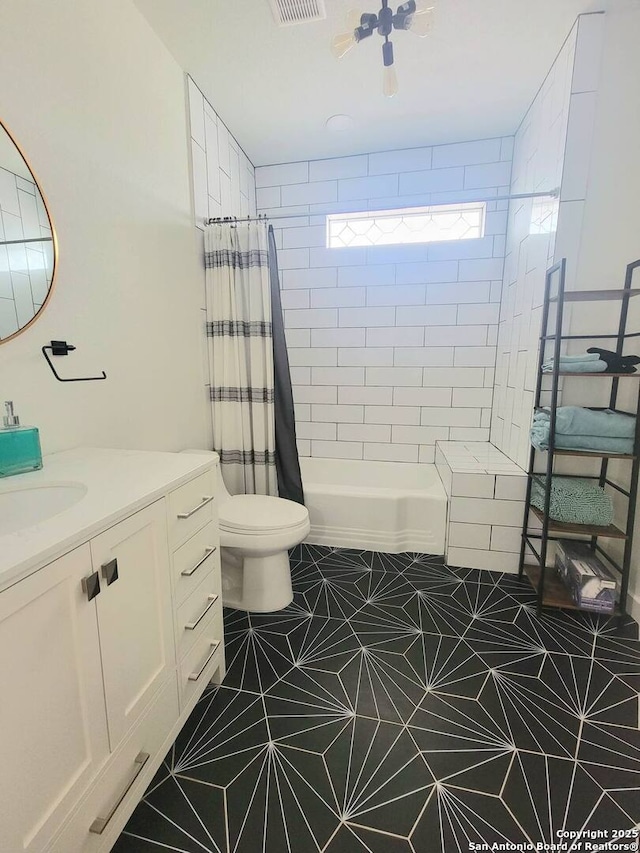 bathroom featuring toilet, vanity, and tile patterned flooring