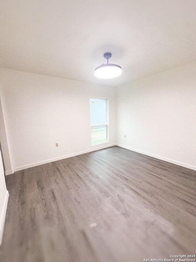 spare room with dark hardwood / wood-style floors