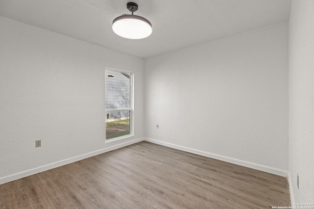 empty room with hardwood / wood-style floors