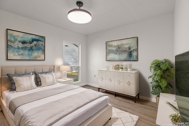 bedroom with light hardwood / wood-style floors