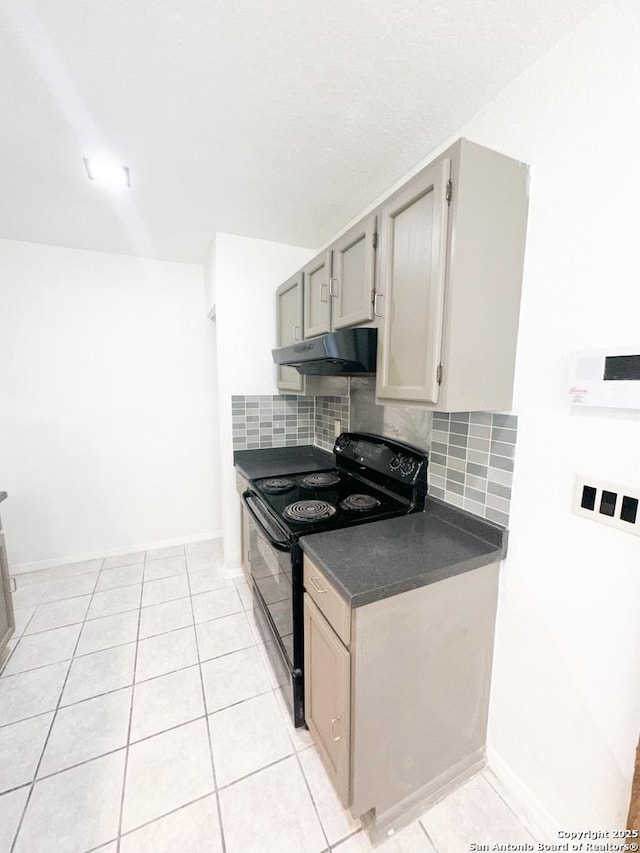 kitchen with light tile patterned flooring, black range with electric stovetop, and backsplash